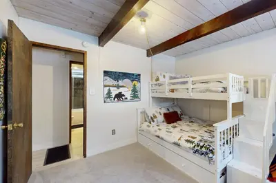 a bedroom with two bunk beds and a hallway at Sioux Serenity in South Lake Tahoe