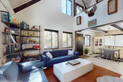 a living room with a blue couch and a table at Sioux Serenity in South Lake Tahoe