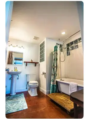 a bathroom with a tub and a toilet and a sink at Alta Peak House in Three Rivers