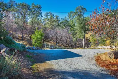 a gravel road with trees in the background at Alta Peak Penzion in Three Rivers
