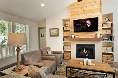 a living room with a fireplace and a tv at Yosemite's Meadow Haven 2358 in Wawona
