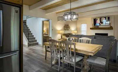 a dining room and living room with a table and chairs at Yosemite's Meadow Haven 2358 in Wawona