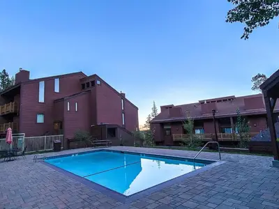 a swimming pool in front of a building at Walk to Canyon Lodge Ski back Modern Space in Mammoth Lakes