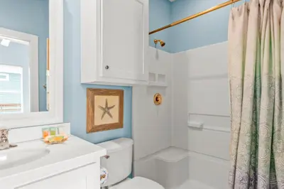 a bathroom with a white toilet and a shower at Why Knot Relax - Heated PRIVATE Pool Beach Gear Credit Included in Fresno