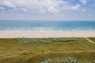 an aerial view of a beach and the ocean at Why Knot Relax - Heated PRIVATE Pool Beach Gear Credit Included in Fresno