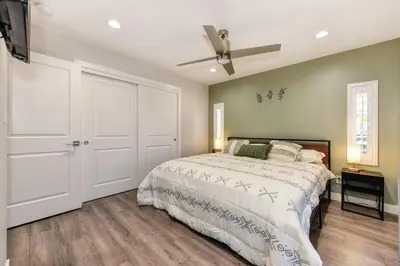 a bedroom with a bed and a ceiling fan at Charming Home, near beautiful park and tennis courts! in Roseville