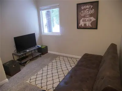 a living room with a couch and a flat screen tv at 725 Lynda Court Incline Village Nevada USA in Incline Village