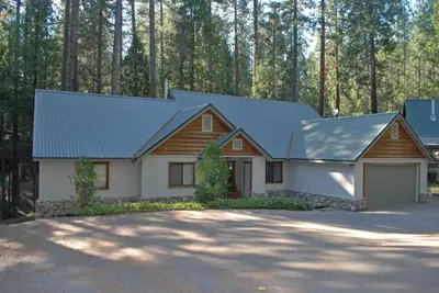 a house with a metal roof and a garage at Doyle's Mountain in Wawona