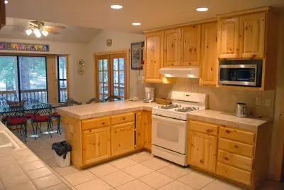 a kitchen with wooden cabinets and a stove top oven at Doyle's Mountain in Wawona