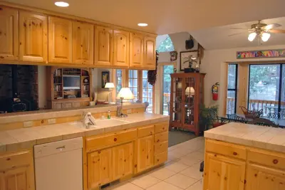 a large kitchen with wooden cabinets and a kitchen island at Doyle's Mountain in Wawona