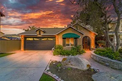 a house with a driveway and a garage at Casita Andrade in Turlock