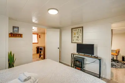 a bedroom with a bed with a tv and a fireplace at Walk to Beach Dog-Friendly Cabin in Glenbrook! in Glenbrook