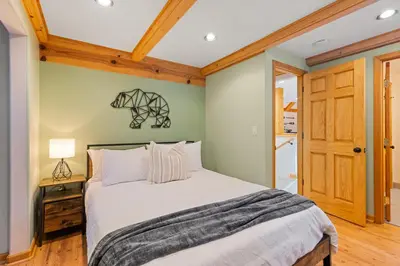 a bedroom with a bed and a wooden ceiling at Remodeled 4BDR Cabin with AC Lake Views Hot-Tub Bunk Room Excellent Location in Kings Beach