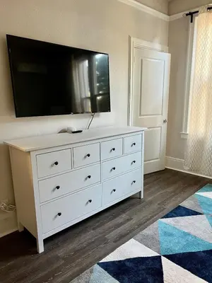 a white dresser with a television on top of it at Cozy Tower Hideaway in Fresno