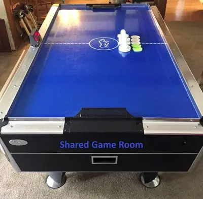 aamed game room with two cues on top of it at Cozy Tower Hideaway in Fresno