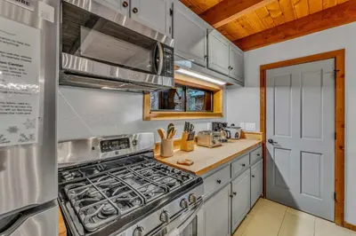 a kitchen with a stove and a sink at Cozy Truckee Vacation Rental with Fireplace & Deck in Truckee