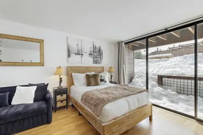 a bedroom with a bed and a large window at Snowpeak Serenity in Truckee