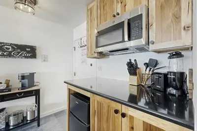 a kitchen with a counter top with a microwave at Snowpeak Serenity in Truckee