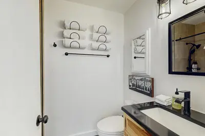 a bathroom with a toilet and a sink and a mirror at Snowpeak Serenity in Truckee