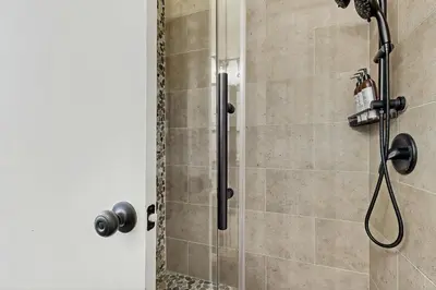 a shower stall with a glass door and a shower constructor at Snowpeak Serenity in Truckee