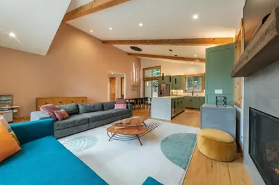 a large living room with a couch and a table at Radiant Retreat by Tahoe Getaways - 4 BR in Tahoe Donner with Hot Tub & HOA in Truckee