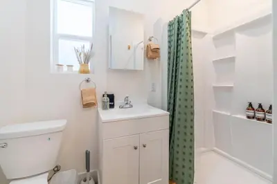 a bathroom with a sink and a shower curtain at Charming Family 2BR Midtown Reno - Pets Welcome in Reno