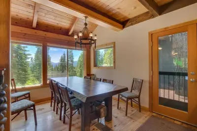 a dining room with a wooden table and chairs at Hyphen 3-bedrooms rental, private beach, filtered view in Tahoe City