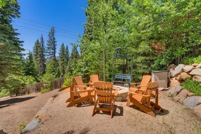 a group of chairs and a table in the sand at Hyphen 3-bedrooms rental, private beach, filtered view in Tahoe City