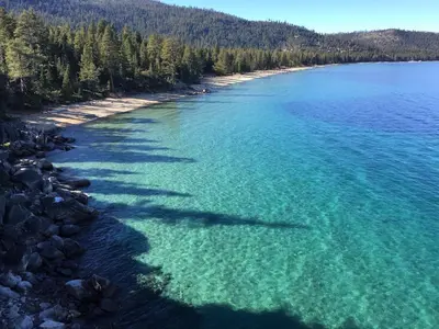 an aerial view of a beach with turquoise water at Hyphen 3-bedrooms rental, private beach, filtered view in Tahoe City