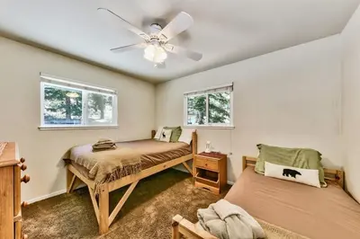 a bedroom with two beds and a ceiling fan at Bear Haus - Sledding At Cabin - Forest Views - Foosball in South Lake Tahoe