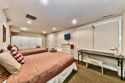 a bedroom with two beds and a desk in it at Bear Haus - Sledding At Cabin - Forest Views - Foosball in South Lake Tahoe