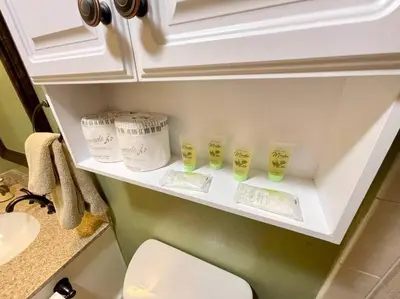 a shelf in a bathroom with four cups on it at Bear Chalet - Snow Play - 4 Bedrooms - Foosball in South Lake Tahoe