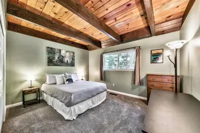 a bedroom with a bed and a wooden ceiling at Bear Chalet - Snow Play - 4 Bedrooms - Foosball in South Lake Tahoe