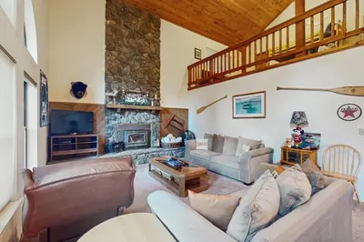 a living room with a couch and a fireplace at Bearfoot Getaway in Shaver Lake