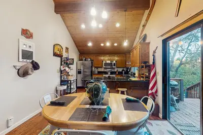 a kitchen with a wooden table and chairs in it at Bearfoot Getaway in Shaver Lake