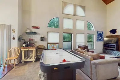 a living room with a pool table in it at Bearfoot Getaway in Shaver Lake