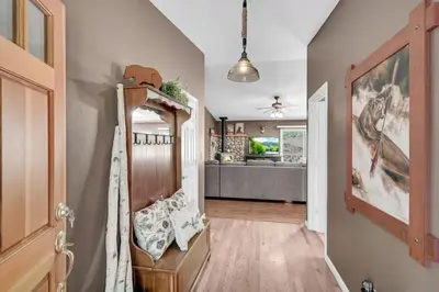 a hallway with a living room with a couch at Great Cabin with AC Firepit Fireplace in Arnold