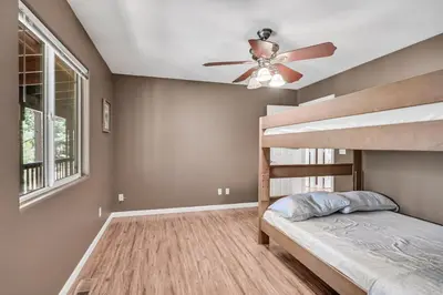 a bedroom with a ceiling fan and a bunk bed at Great Cabin with AC Firepit Fireplace in Arnold