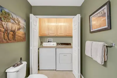 a small bathroom with a washer and dryer at Great Cabin with AC Firepit Fireplace in Arnold