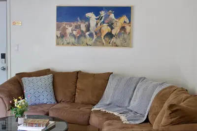 a couch in a living room with a painting on the wall at Whispering Pines in June Lake