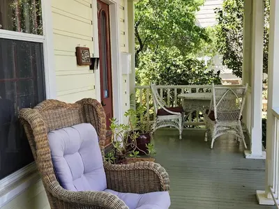a porch with wicker chairs and a table on a house at Brinnwood Bed & Breakfast in Sutter Creek