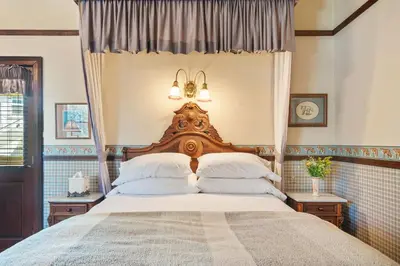 a bedroom with a large bed with a canopy at Brinnwood Bed & Breakfast in Sutter Creek
