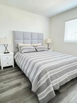 a bedroom with a large bed with a striped blanket at Orchard Parks in Tracy