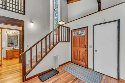 a staircase in a home with a wooden door at Cozy Carnelian Bay Escape with Deck and Foosball in Carnelian Bay