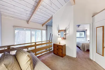 a bedroom with a couch and a bed in a room at Sierra Park Villas 40 H in Mammoth Lakes