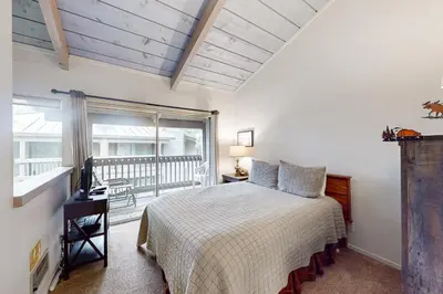 a bedroom with a bed and a balcony at Sierra Park Villas 40 H in Mammoth Lakes