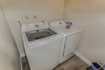 a white washer and dryer in a small room at Reno Retreat 3 King Beds by Casinos and University in Reno