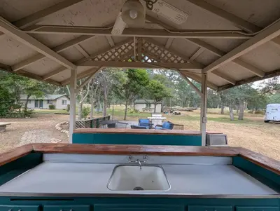 an outdoor kitchen with awning and a sink at Squaw Valley Motel Room #1 in Squaw Valley