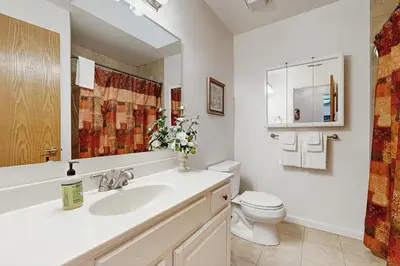 a white bathroom with a sink and a toilet at Casa Cardoso in Groveland
