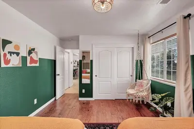 a bedroom with green and white walls and a bed at Yosemite & Bass Lake 3 Acres, Pool, Game Room, Stunning Views in Coarsegold